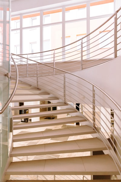 White with a white metal railings in spiral staircase
